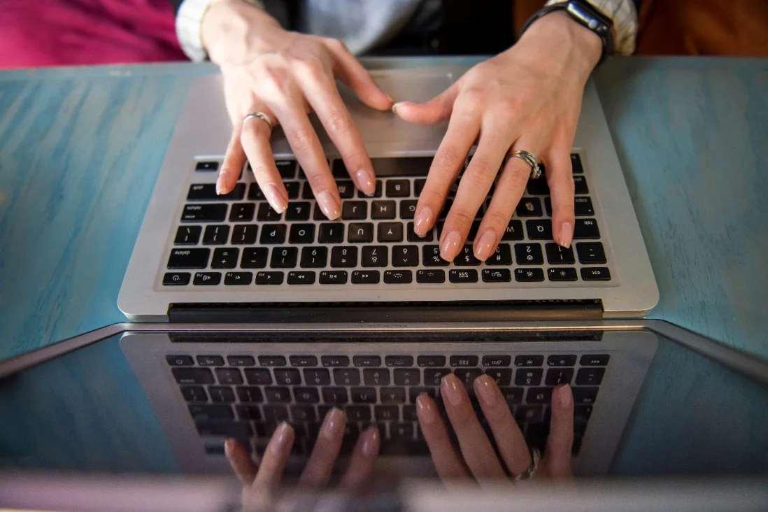 Two colleagues looking at a laptop together